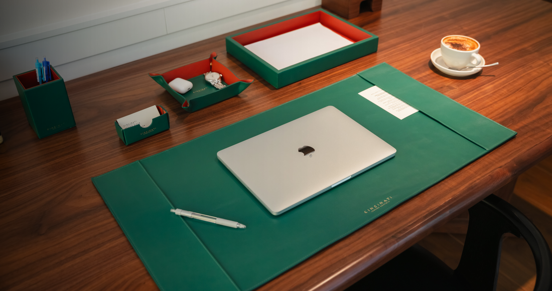 Leather office desk set with desk mat, trays and pen holder on a wooden desk